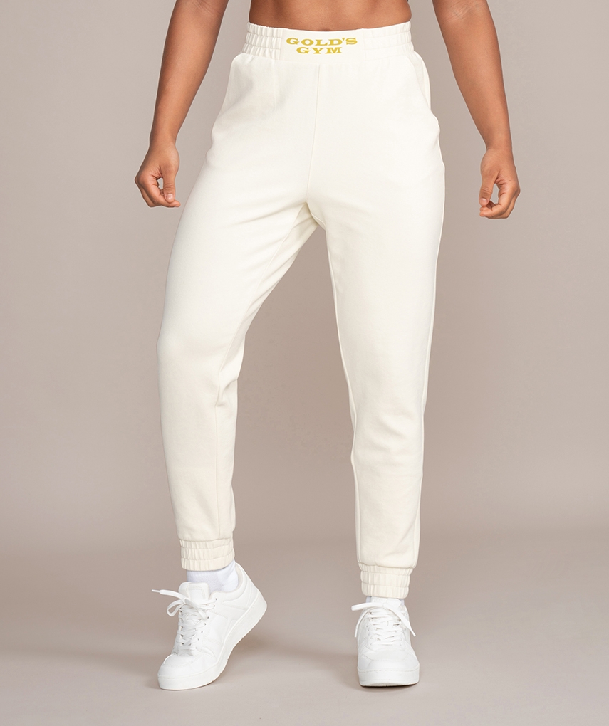 White women's sweatpants from Gold's Gym. Tight-fitting long women's trousers with elasticated ribbed cuffs, front welt pockets and Gold's Gym lettering on the waistband.