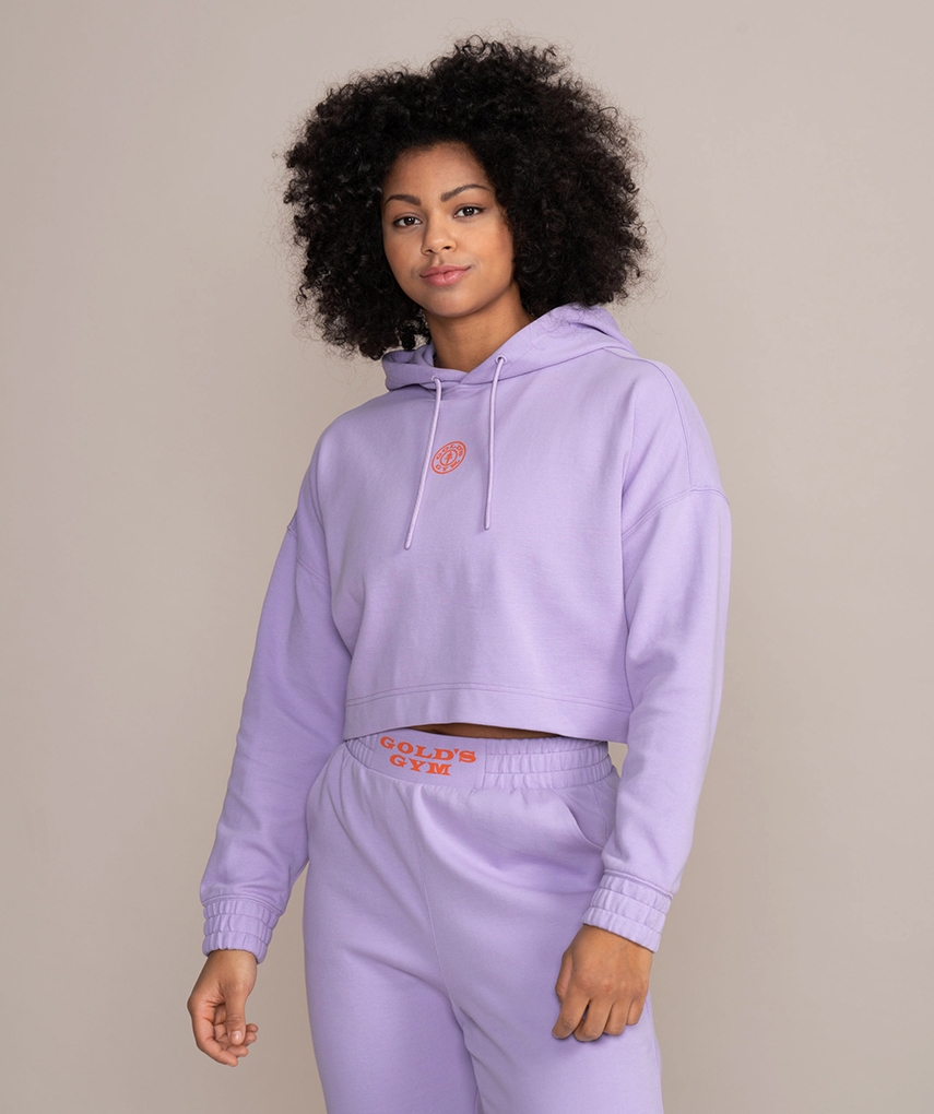 Lavender women's cropped hoodie from Gold's Gym. Women's long sleeve cropped hooded top with drawstrings and Gold's Gym Weight Plate logo on the front.