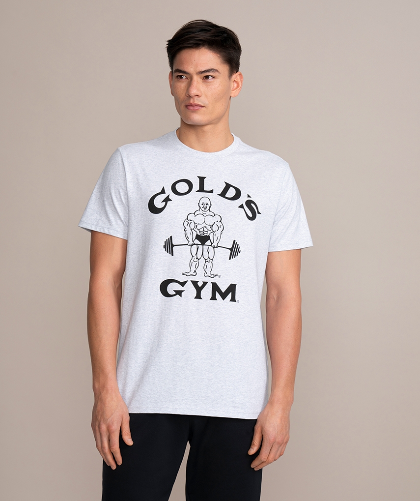 Graues Sport T-Shirt von Gold’s Gym. Kurzarm mit dem weißen Classic Joe Logo und gelber Schrift auf der Brust.  