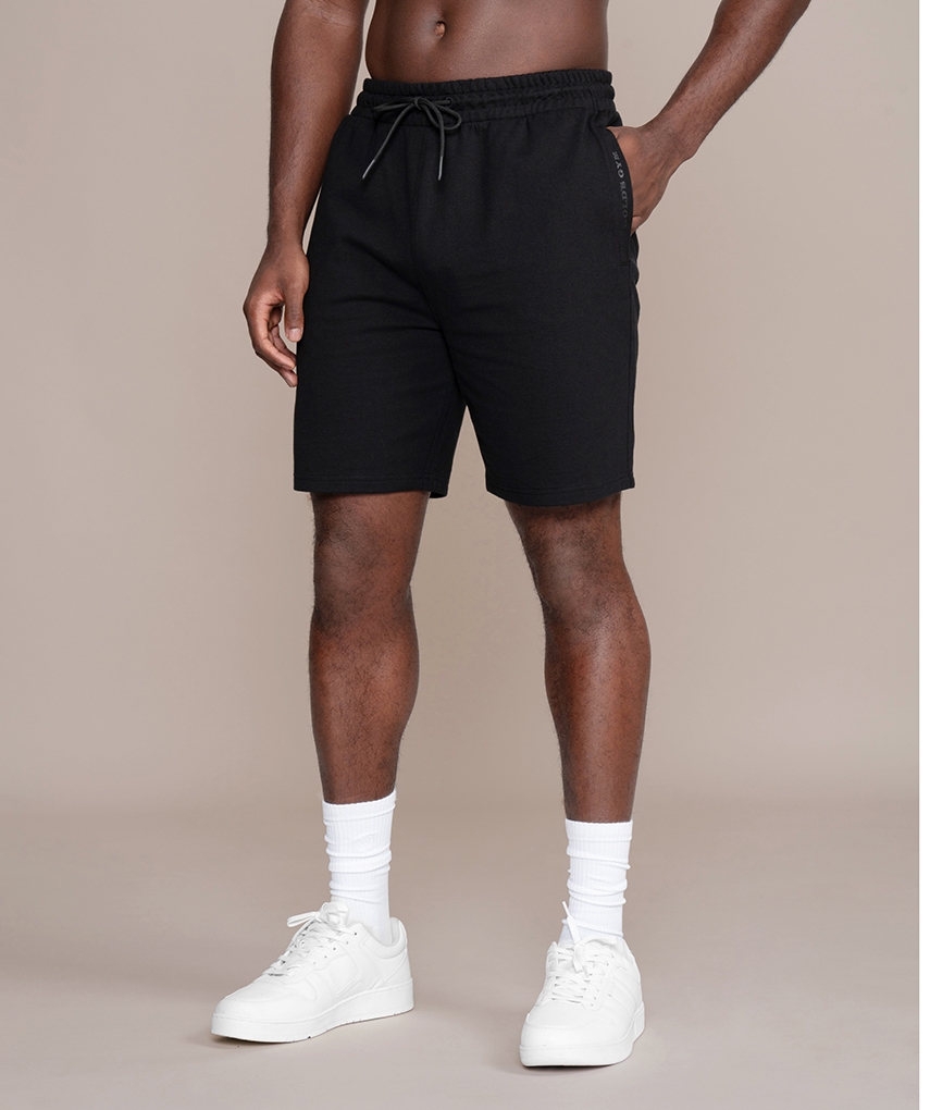 Schwarze Sweat Shorts von Gold’s Gym. Kurze Hose aus Sweatstoff mit elastischem Bund und Kordelzug. Eingriffstaschen vorne und aufgesetzte Tasche hinten.
