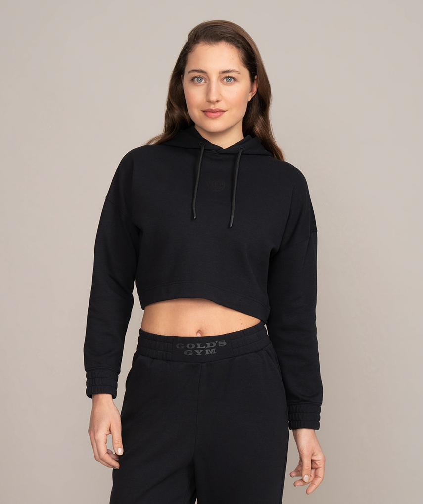 Black women's cropped hoodie from Gold's Gym with small Weight Plate logo on the chest and small Muscle Joe logo on the back. 